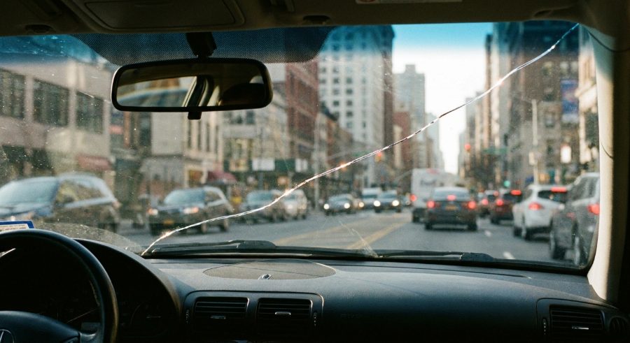 Long crack running across a windshield while driving in traffic